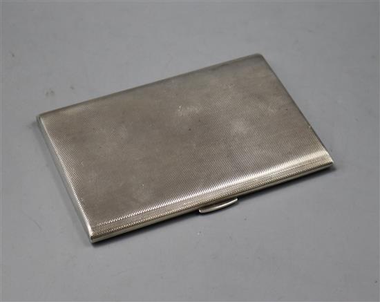 A 1960s engine turned silver cigarette case, gross 5 oz.